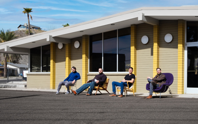 Joe McCallum (left), Adam McCallum, Frank Malefors and Ryan Mapes sit in front of the former Eye Opener Family Restaurant, where they plan to open a vintage furniture store that will be called Eye Opener (photo by Miles McDermott).