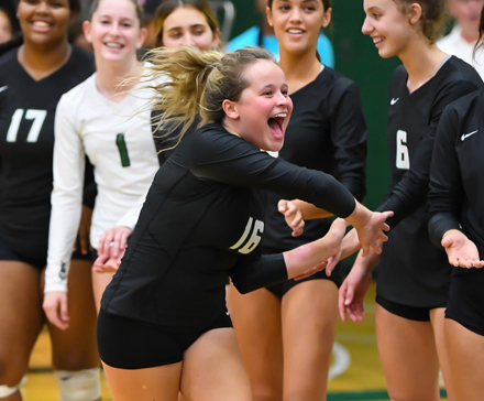 Avery Morkert, now a senior at Sunnyslope High School, bonds with the other members of the varsity volleyball team. She has bounced back after receiving a liver transplant and suffering other major health issues (photo by Mark Jones).
