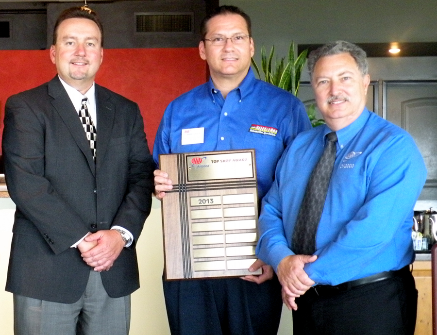 Jesse Garcia (center), from Kelly Clark Automotive Specialists at 12th Street and Glendale Avenue, accepts the AAA 2013 Top Shop plaque from John Walter, left, and Don Nunnari, right, of AAA Arizona (photo courtesy of AAA Arizona).