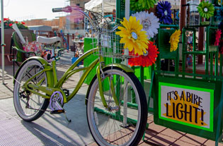 Did you know that if you ride your bicycle after sunset, Arizona law requires you to have a front light? That doesn’t mean it has to be a boring one. Lynn Teitel of Pedal Brite in Scottsdale sales flower bike lights that add some style to your cruiser’s bike basket. She will be at the Sunnyslope Art Walk at Central and Dunlap avenues on Saturday, April 12 (submitted photo).