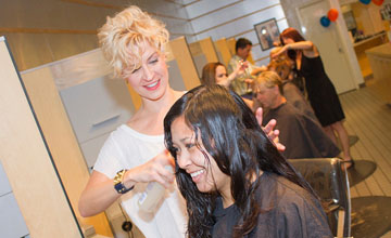 Ronda Gates, a stylist at Mane Attraction salon, works on a customer’s hair. The salon and its stylists will participate in a fundraiser this month for Phoenix Children’s Hospital (submitted photo).