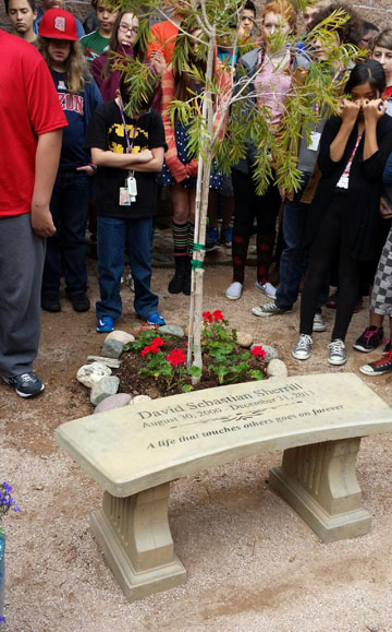 Former classmates and friends of Madison No. 1 student David Sebastian Sherrill, who was killed on Dec. 31, 2013, gather around a memorial garden installed in his honor outside the school library. The garden was dedicated on Dec. 17, 2014 (photo courtesy of the Madison School District).