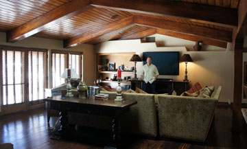 North Central realty expert Bobby Lieb of HomeSmart Elite Group stands inside the family room of the former McCain home on Central Avenue, currently for sale for $2.5 million. The home features original wide-plank floors throughout as well as original wood beams (photo by Teri Carnicelli).