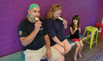Cooling off with an afternoon treat at the new AZ Pops are Doug and Kathi Boggess of Waterwise Irrigation, with their granddaughter, Melissa, 4. Doug is enjoying a mango black cherry, Kathi is trying the cucumber watermelon and Melissa knew exactly what she wanted—chocolate coconut (photo by Teri Carnicelli).