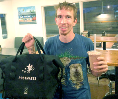 Paul Jones delivers a burger and shake from The Stand to a hungry customer. The Postmates bag keeps hot food hot and cold food cold (submitted photo).