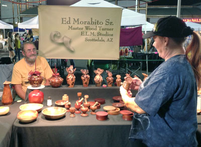 Kathleen Freedman chats with Master Wood Turner Ed Morabito Sr. of E.L.M. Studios during last fall’s Sunnyslope Art Walk. Morabito, who teaches classes at the nonprofit S.E.E.D.S. for Autism, is a regular exhibitor at the twice-yearly art event in Central Phoenix (photo by Teri Carnicelli).