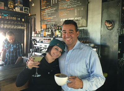 Rebecca Golden and one of her many regulars, Carlos Arboleda, show off two of their favorite drinks: for her, a Mint Lemondrop Martini, and for him, his regular cup of mocha. 32 Shea is both cafe and bistro depending on the time of day (photo by Patty Talahongva).