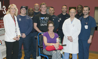 Abrazo Arizona Heart Hospital patient Michelle Dean and her son, Alex (behind her), gave a grateful thank you to the Phoenix firefighters from Station 17 who saved her life and kept her heart beating after she collapsed outside of work on Jan. 25 (photo courtesy of Abrazo Community Health Network).