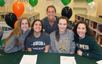 Sunnsylope High School Volleyball Coach Amber LeTarte, who was named the Division 1 Coach of the Year for 2015, congratulates her student athletes on their future college careers, from left: Skyler Wine, Sarah Marinez, Emma Wright, and Katie Oleksak (photo by Teri Carnicelli).