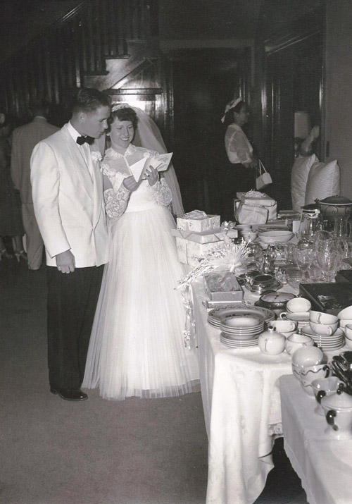Ellis and Sally Shackelford browse through their wedding gifts and cards on the day of their marriage, Aug. 15, 1953, at the Ellis-Shackelford Home in downtown Phoenix (photo courtesy of the Shackelford family).