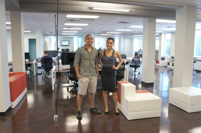 Odeen Domingo and wife Jenny Poon, co-owners of CO-HOOTS, stand in one of the large open shared working areas available at their new location, inside a 1960s midcentury modern office building at 221 E. Indianola Ave. The unique building is one of the few original structures raised up on stilts that remain in the Central Phoenix area (photo by Teri Carnicelli).