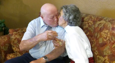 The flame is still burning for Dean and Mary Jones, who celebrate their 70th wedding anniversary with a toast and a kiss (submitted photo).