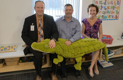 Enjoying the natural light and kid-friendly window sitting space inside one of the new Madison Simis kindergarten classrooms are, from left: Quinn Kellis, superintendent of the Madison Elementary School District; Steve Poulin, project director, McCarthy Building Companies; and Joyce Flowers, principal of Madison Simis (photo by Teri Carnicelli).