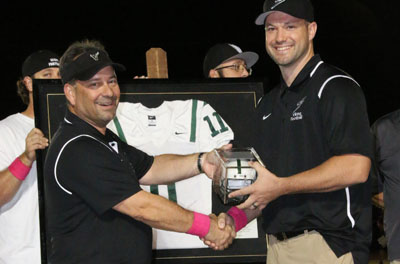 Kevin Hanson, left, president of the Vikings Booster Club, presents former Sunnyslope High School football player Mike Nixon with a commemorative helmet during a special ceremony on Oct. 7 where Nixon’s No. 11 jersey was officially retired (photo courtesy of Sunnyslope Football).