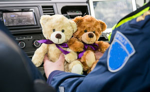Officer gathers plush animals to hand out