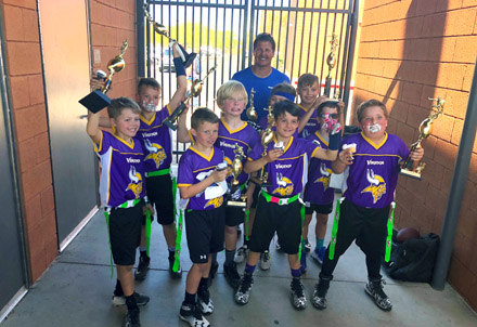 Local youth capture flag football trophy