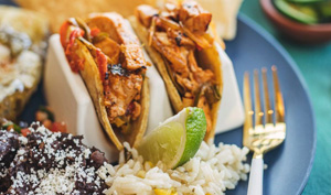 Feast on family meal with tacos, beans, guacamole