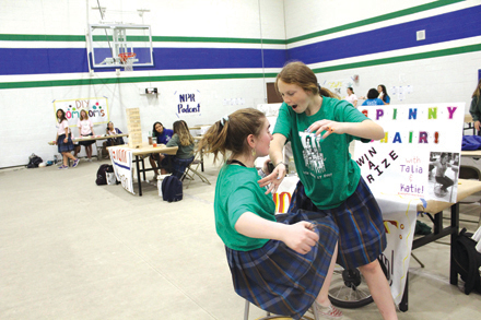 Talia Novak, on the left, a senior this school year, and Katie Harris, also a senior at Xavier College Preparatory demonstrate a centrifugal force activity during last year’s Girls Have IT Day (GHITD) (photo by Dominique Paplaczyk).