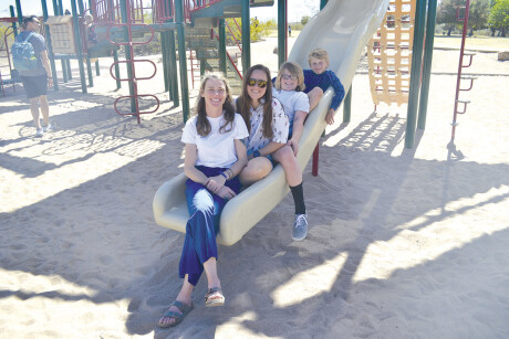 Meredith Russell Francis, in front, her partner Amanda Nieman, and Russell Francis’ two sons, Jackson Francis, 12, and Andrew Francis, 9, bond at Granada Park. Russell Francis and Nieman are examples of the growing number of non-traditional mothers and mother figures in North Central and around the country (photo by Colleen Sparks).