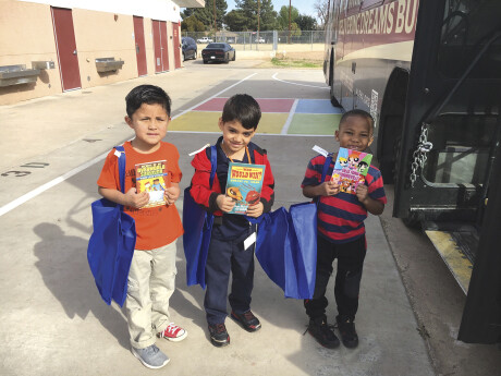 Children receive donations from the Assistance League of Phoenix’s Operation School Bell program. They step aboard a “department store” bus, where they pick out clothes, hygiene kits and books with help from volunteers (photo courtesy of the Assistance League of Phoenix).