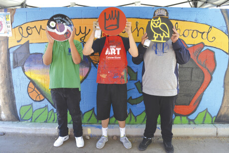 Youths who participated in a Free Arts for Abused Children of Arizona’s Hip Hop Free Arts Day with partner agency Neighborhood Ministries show off the “records” they designed. Free Arts provides arts instruction and activities for youths as ways to help them heal from trauma (photo courtesy of Free Arts for Abused Children of Arizona).