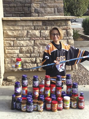 Tyler Ross led a peanut-butter-and-jelly drive by two youth hockey teams to help support the Midtown Primary School’s new food pantry (photo courtesty of Lindy Ross).